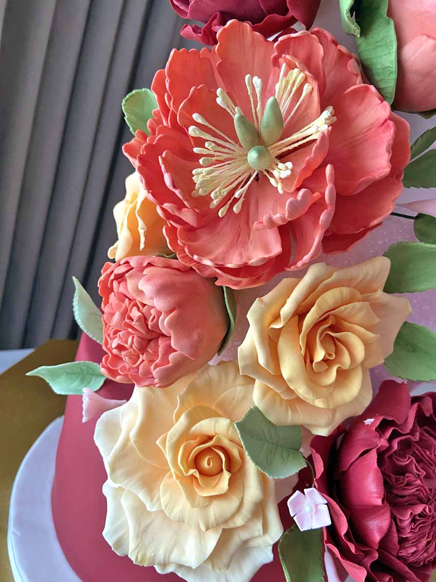 Pink Sugar Flower Decorations On A Wedding Cake